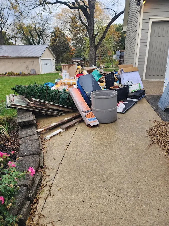 Dumpster being loaded with debris for Demolition Dumpster Rental in Carver
